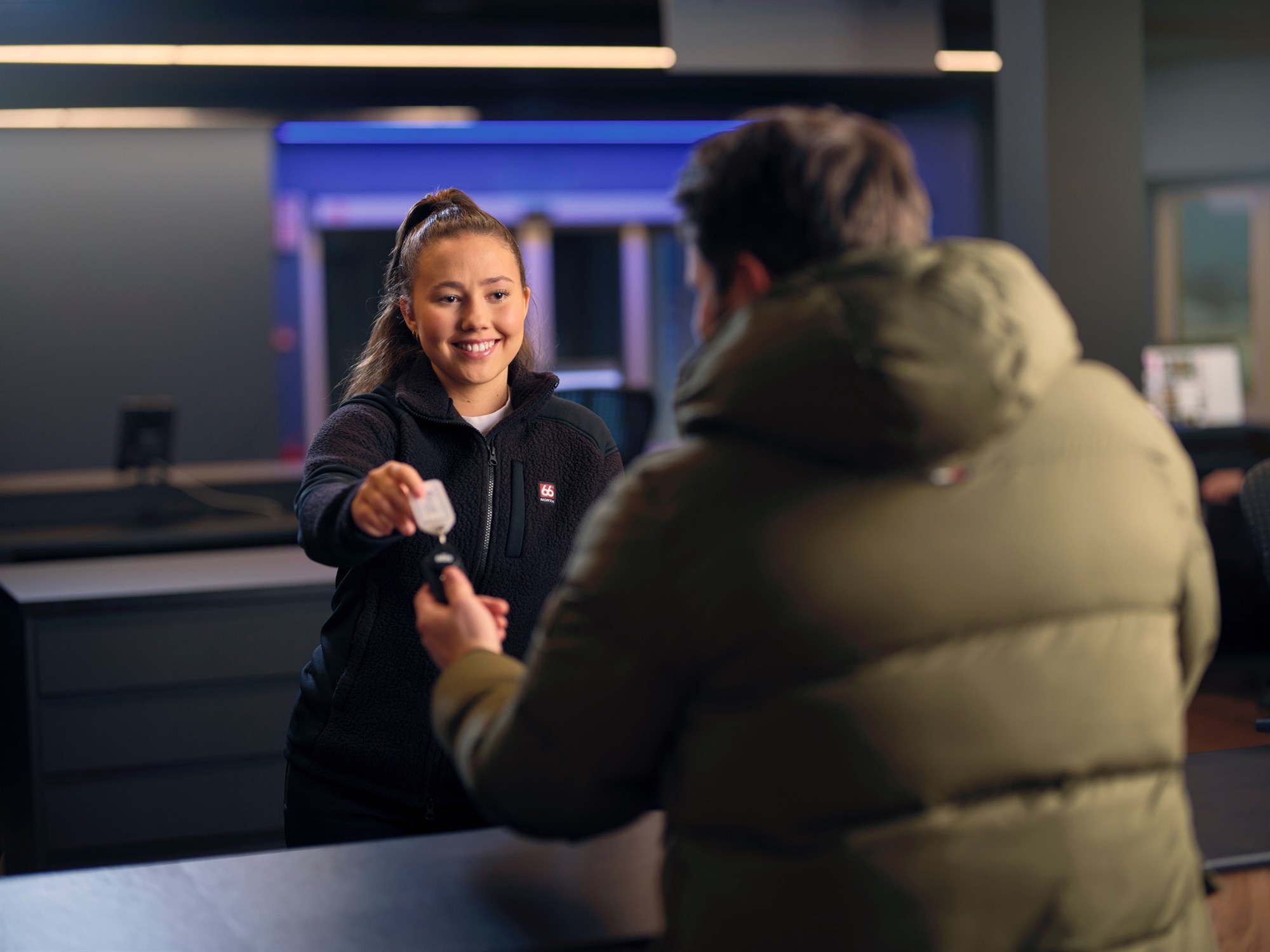 Blue Car Rental Kef airport office. Blue Car Rental staff giving the key to the rental car at Kef airport office.