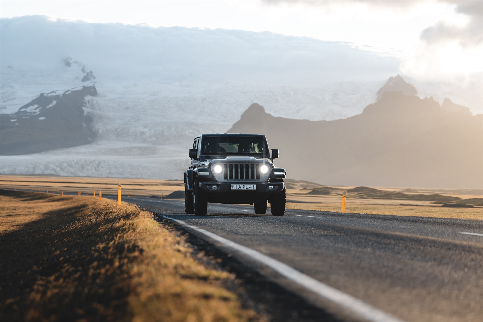 jeep with glacier in the background on the road in iceland.