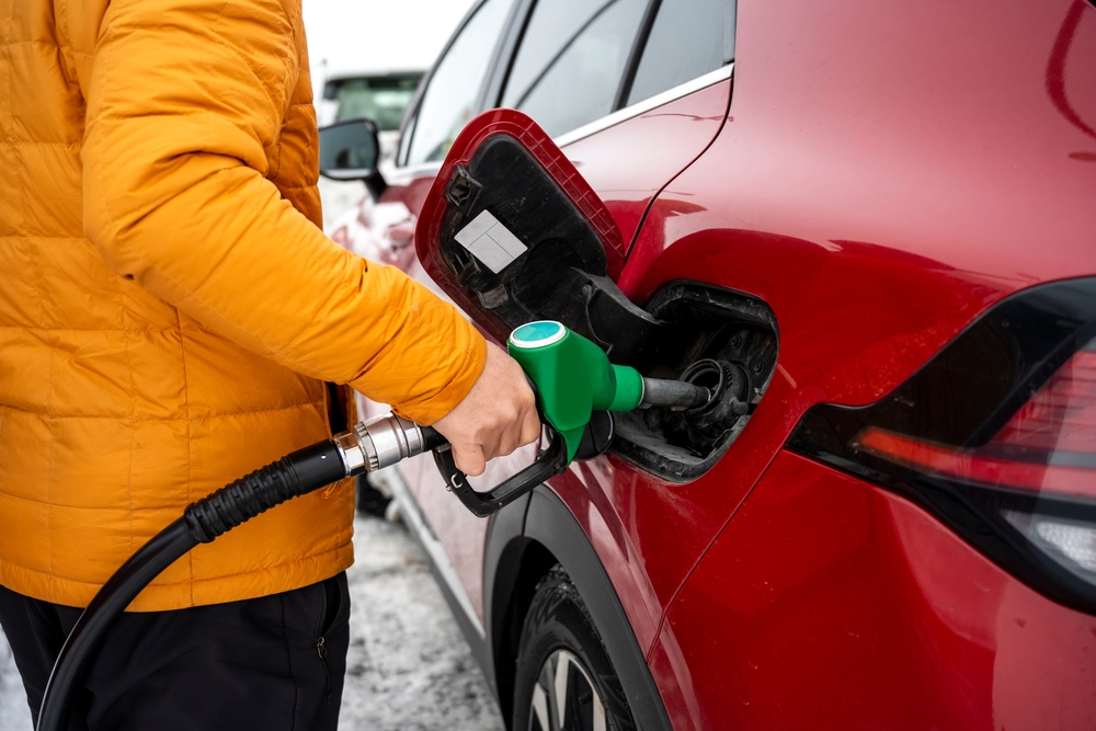 Fuel in Iceland. Customer putting a fuel on a red rental car in Iceland.