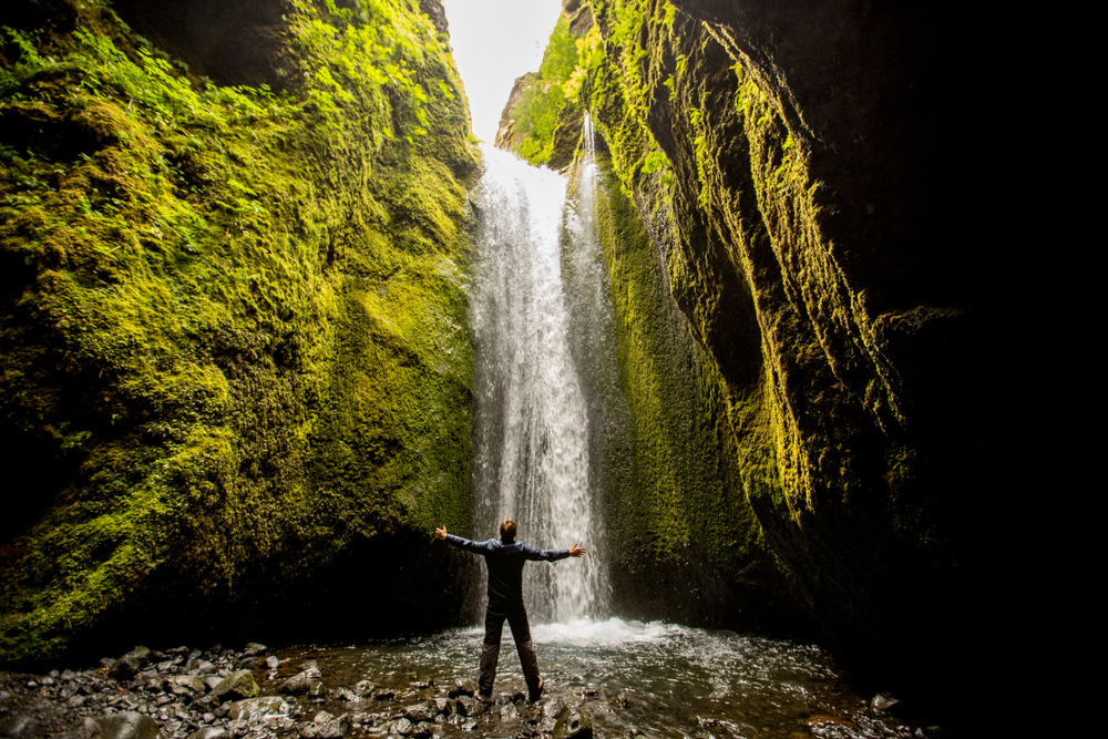 Nauthusagil Man standing in Nauthusagil canyon and waterfall in Icealnd.