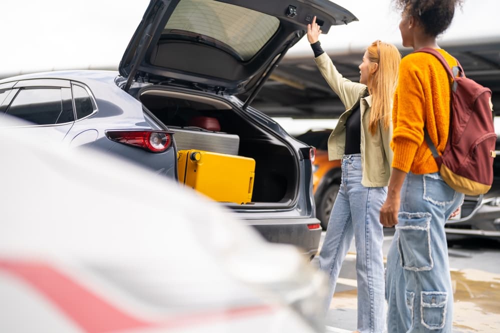 Car rental kef airport. Traveler with rental car closing the boot at Kef airport.