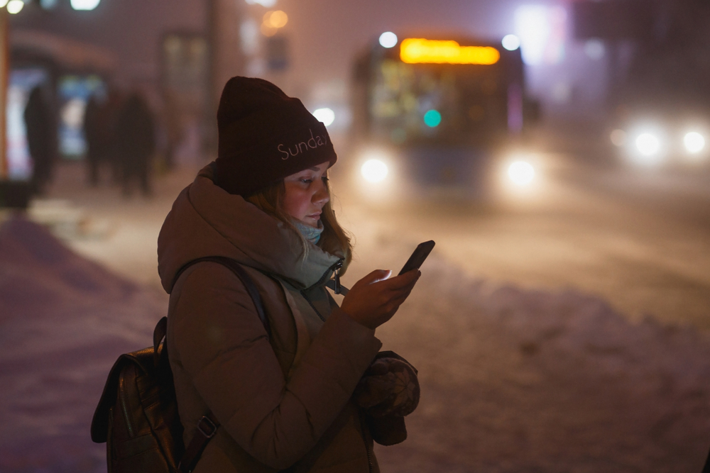 Waiting for a bus. Women standing in the snow waiting for a bus in Iceland.