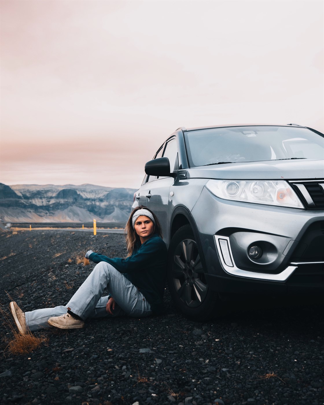 Suzuki Vitara rental car in Iceland. Women sitting by here 4x4 Suzuki Vitara rental car in Iceland.