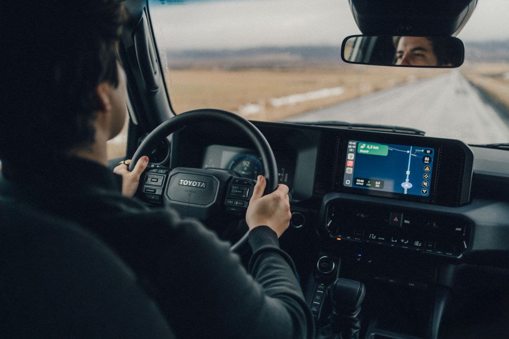 Iceland bathroom guidance. Man driving in Iceland with gps navigation system on.