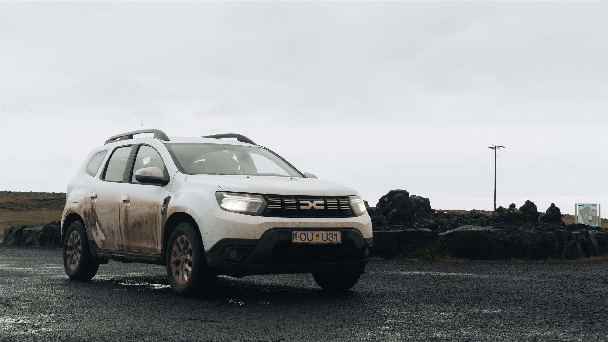 Dirty rental car in Iceland. Dirty white Dacia Duster 4x4.