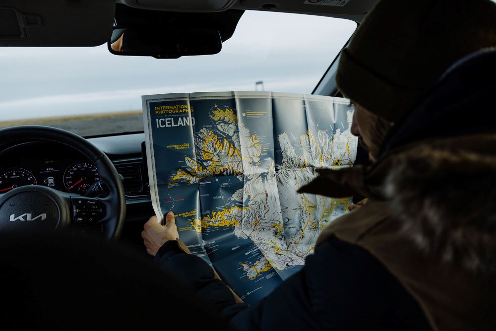 Reading a map of Iceland inside a rental car