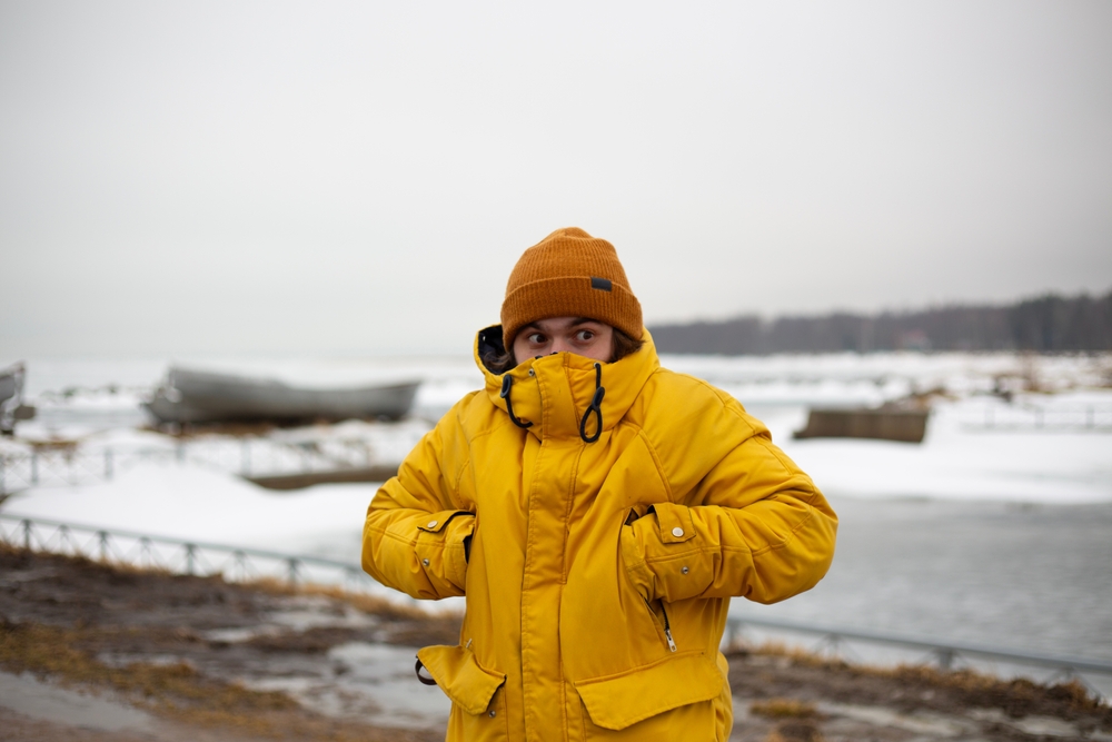 Winter condition in Iceland. Man in a yellow winter jacket in Iceland.