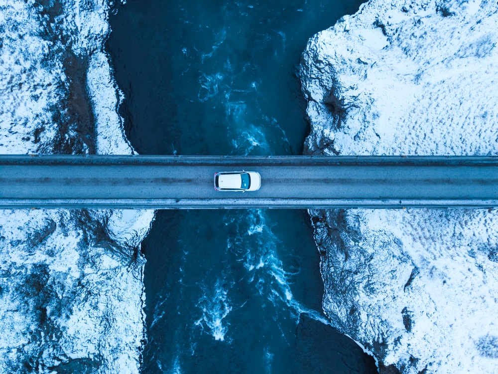 Winter driving in Iceland. Air view of a road and bridge in Iceland in winter.