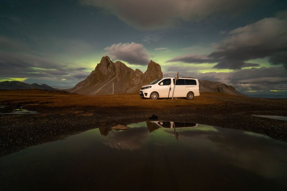 Passenger van under the northern lights in Iceland