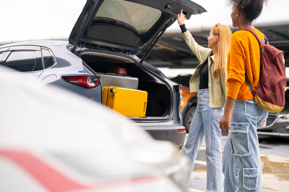 Local car rental at KEF airport. People loading their rental car with luggage at Keflavik airport.