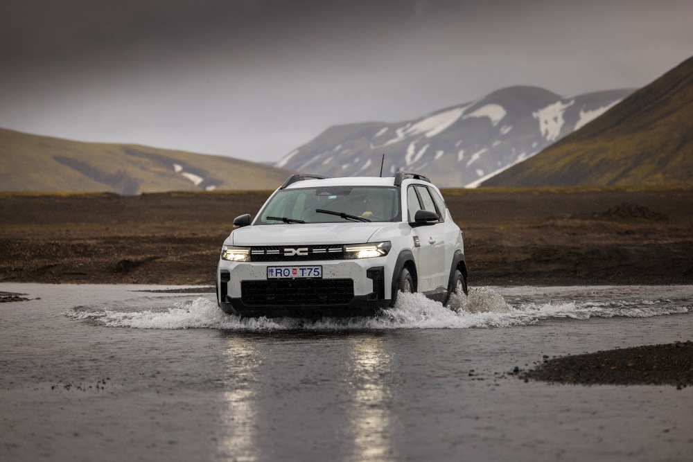 River crossing in Iceland. White Dacia Crossing a river in Iceland.