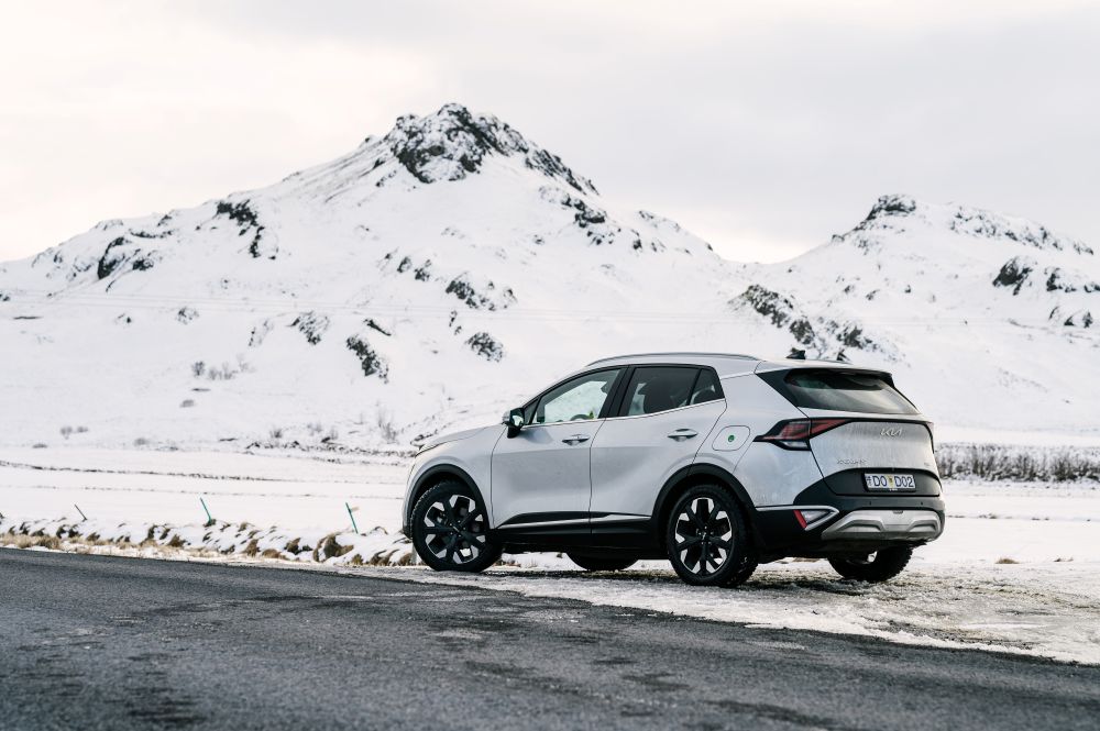 4x4 winter condition. White Kia Sportage rental car in winter conditions in Iceland.