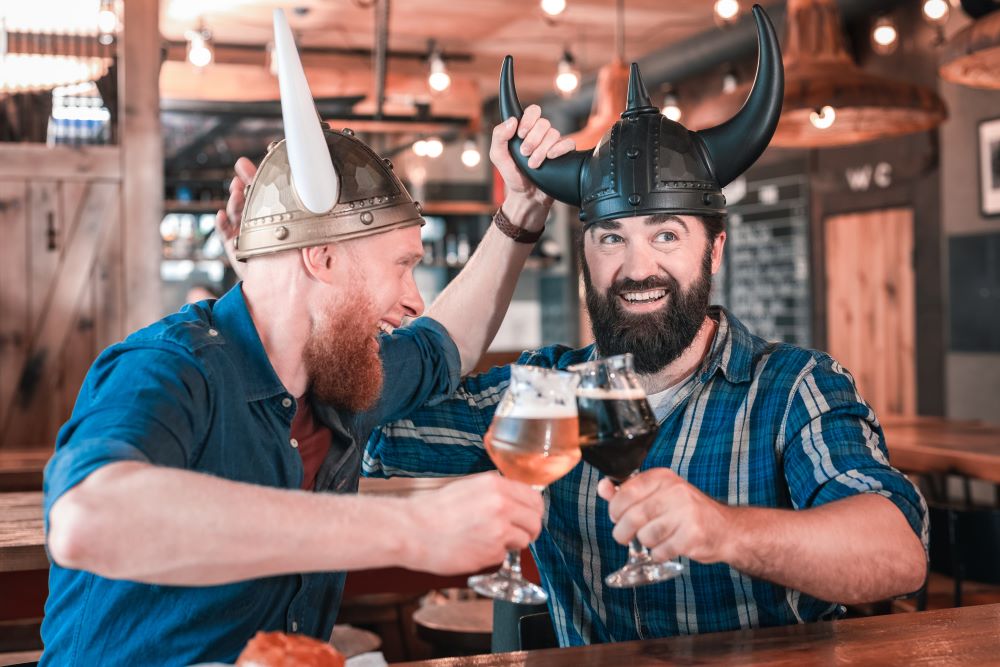 Men with viking hats in Iceland drinking beer. 