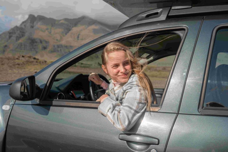 Women looking outside a window on a Dacia Duster rental car 4x4 in Iceland.