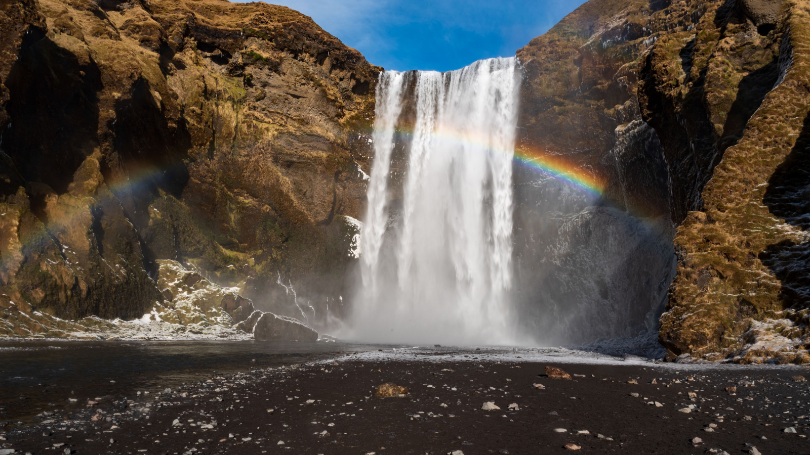 Skogafoss waterfall in winter Skogafoss and rainbow in winer