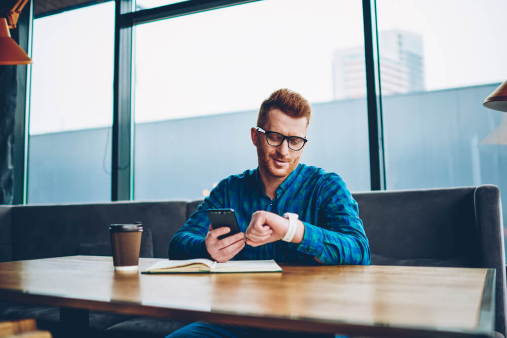 Man checking time. Man checking time before making a car rental booking.