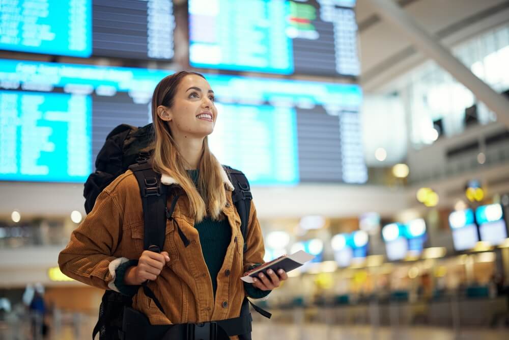 Travel to Iceland. Women traveller standing in Keflavik airport terminal.