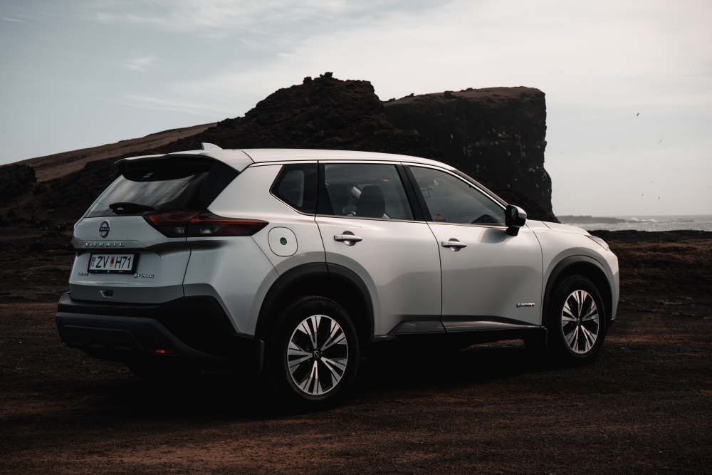 Iceland coast and sea cliffs. Silver Nissan x-trail 4x4 and sea cliffs of the coast of Iceland.