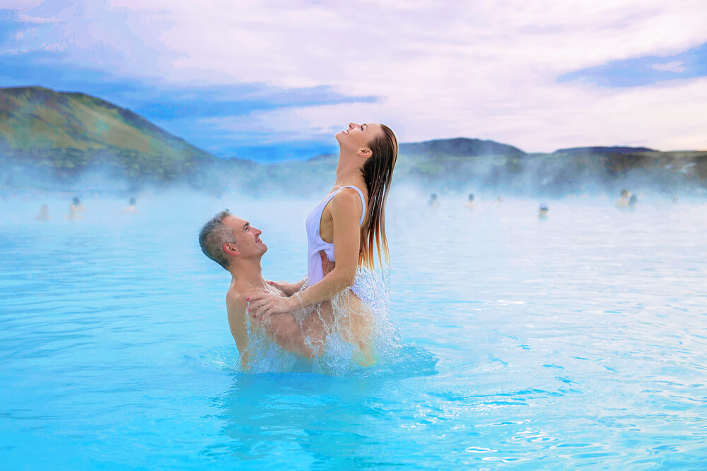 Couple celebrating valentines day in the Blue Lagoon in Iceland.